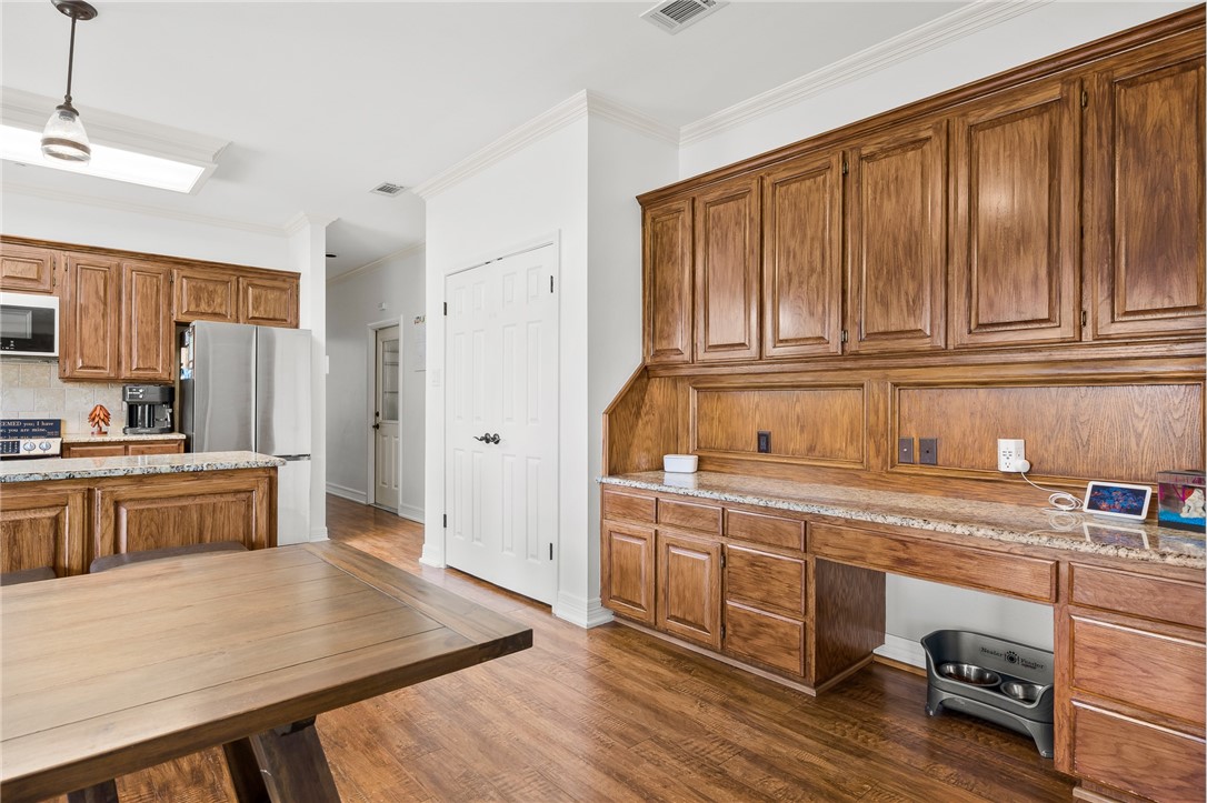 2 Schendel Road Portland, TX 78374 - Photo 11 of 39 a kitchen with a sink a stove cabinets and wooden floor