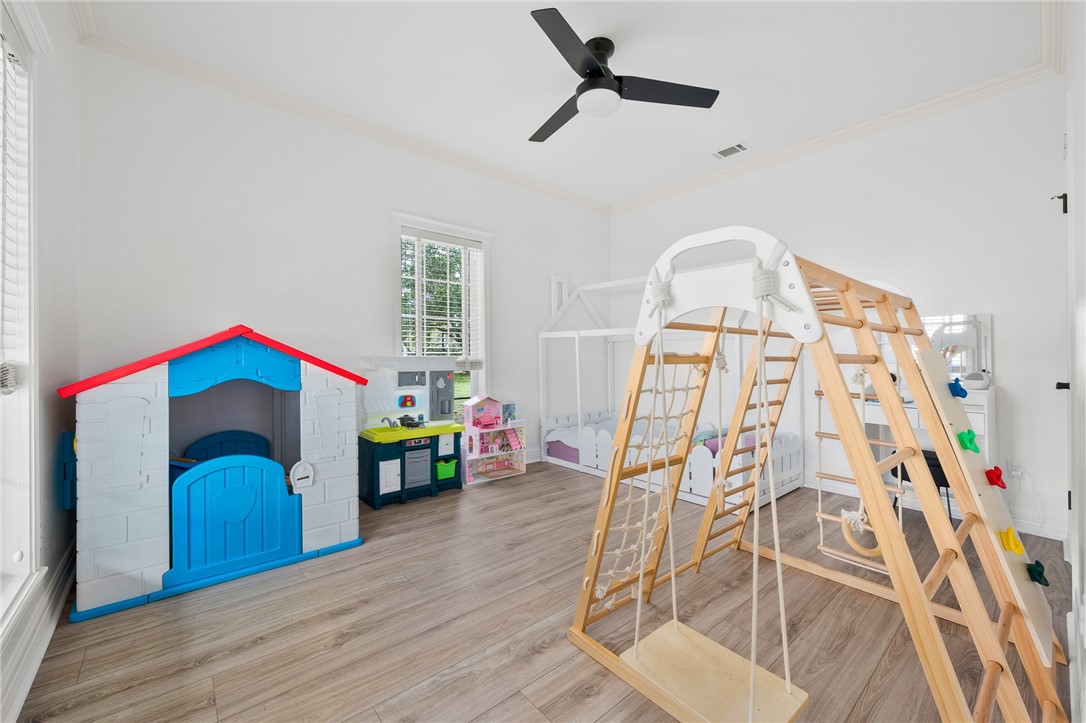 2 Schendel Road Portland, TX 78374 - Photo 18 of 39 a bedroom with a bed and a chandelier