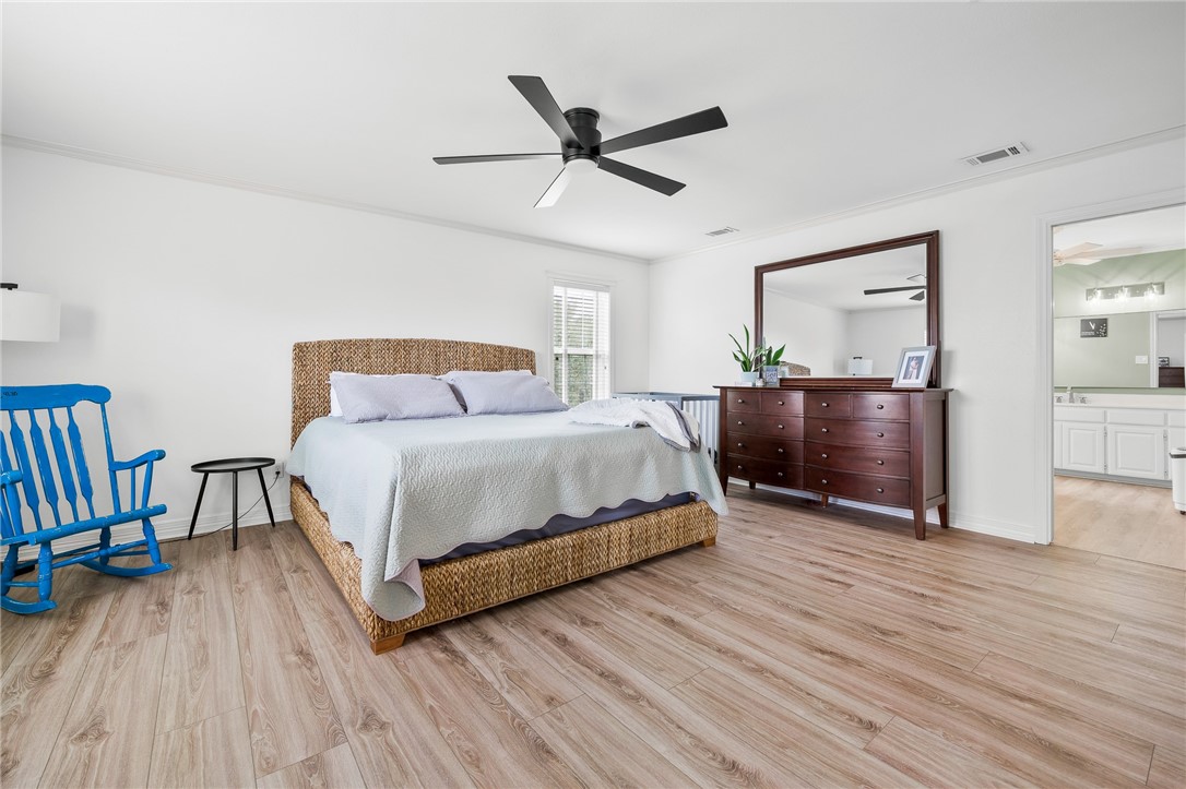 2 Schendel Road Portland, TX 78374 - Photo 23 of 39 a bedroom with a bed and wooden floor