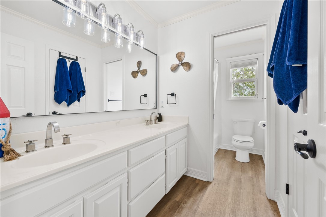 2 Schendel Road Portland, TX 78374 - Photo 28 of 39 a bathroom with a sink a toilet and a mirror