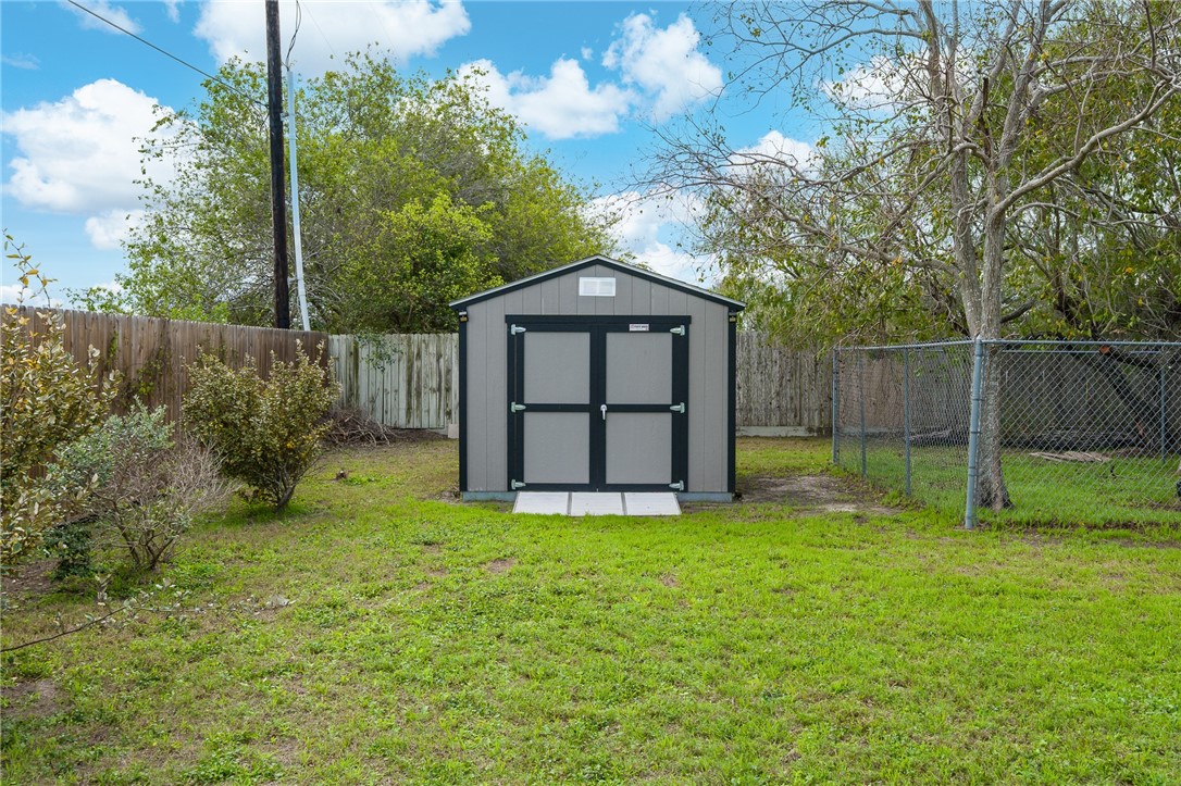 2 Schendel Road Portland, TX 78374 - Photo 32 of 39 a white house with a small yard and large trees