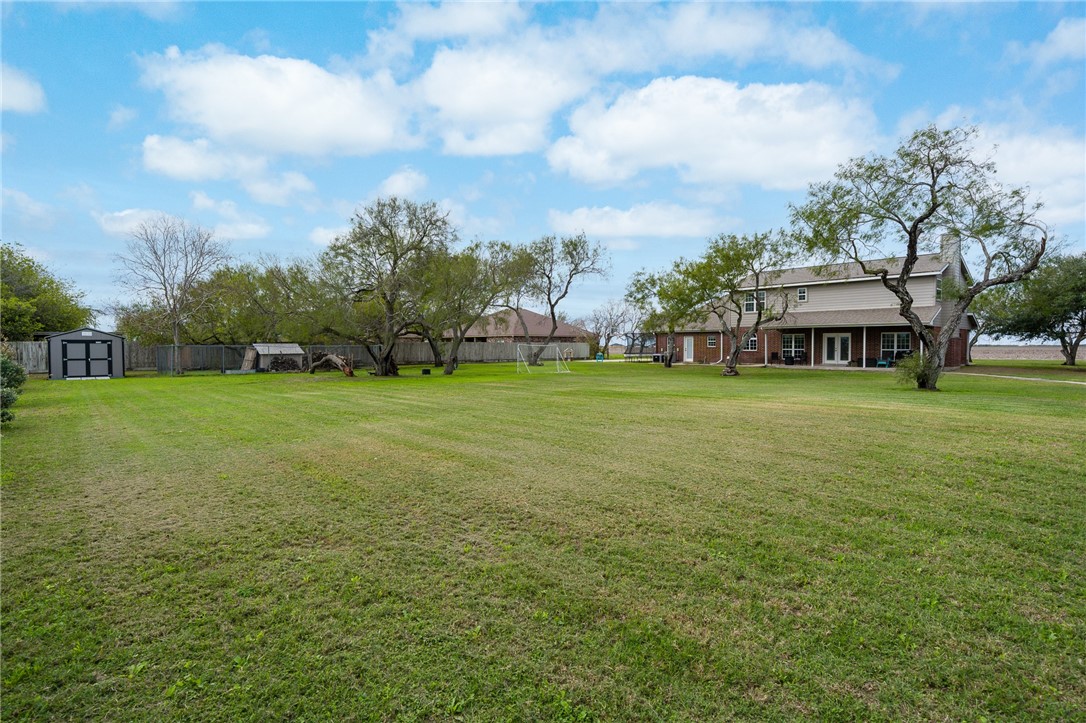 2 Schendel Road Portland, TX 78374 - Photo 4 of 39 a view of a big yard with a building in the background