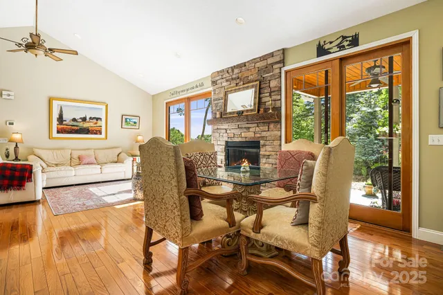 a view of a dining room with furniture a chandelier and wooden floor