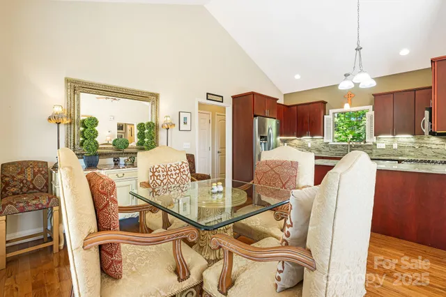 a dining room with furniture and a floor to ceiling window