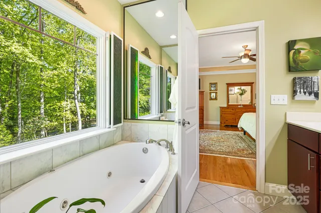 a bathroom with a granite countertop tub and a window