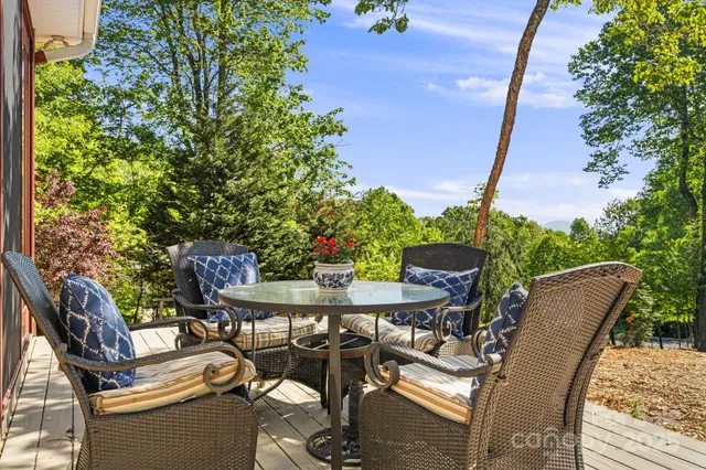 a view of a patio with table and chairs and potted plants