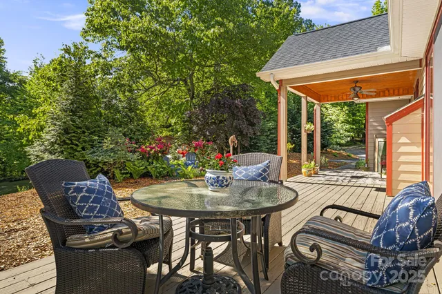 a view of a patio with a table chairs and a potted plant