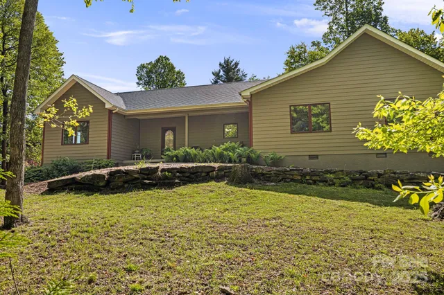 a view of a house with swimming pool and sitting area