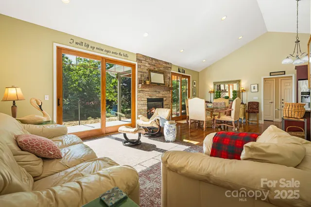 a living room with furniture and large windows