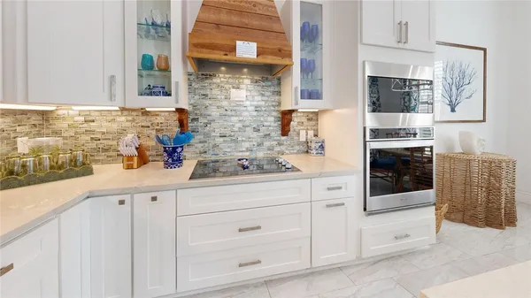 a kitchen with stainless steel appliances white cabinets and a sink