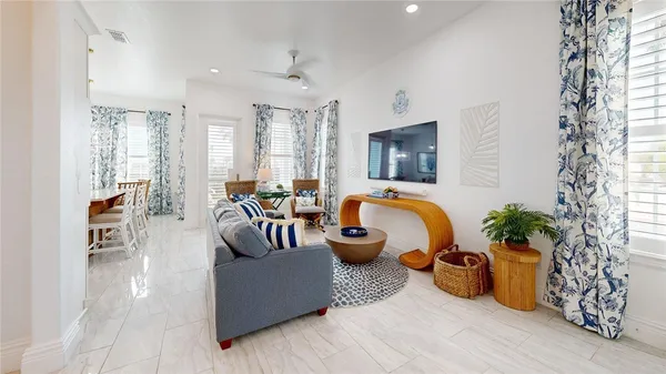 a living room with furniture and a potted plant