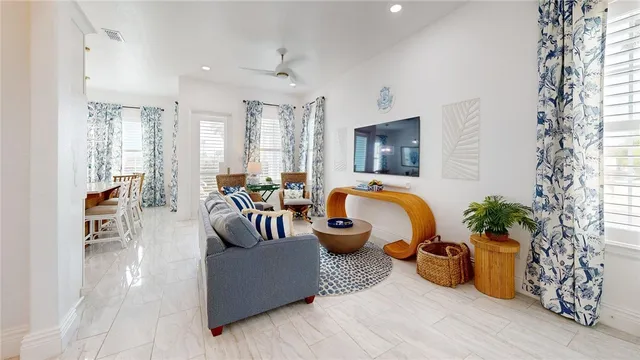 a living room with furniture and a potted plant