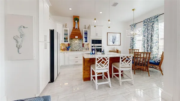 a dining room with furniture and a chandelier