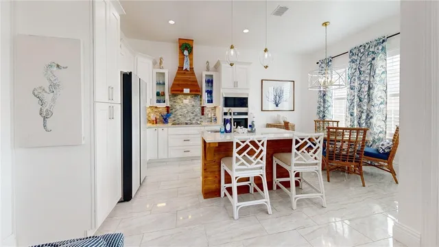 a dining room with furniture and a chandelier