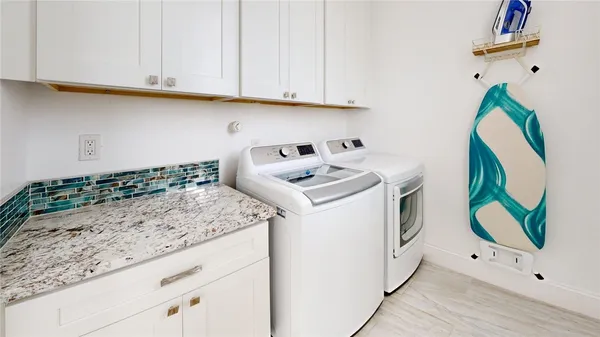 a utility room with washer and dryer