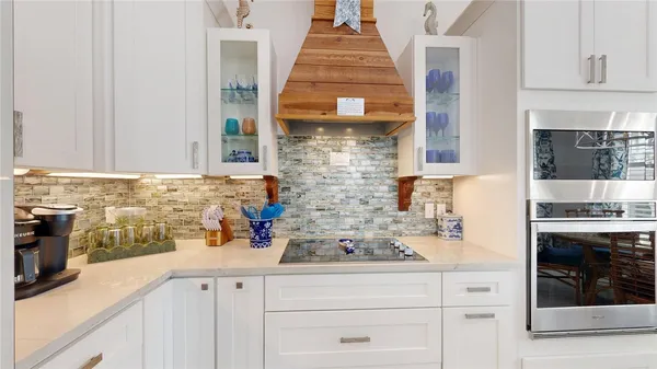 a kitchen with a sink stove and cabinets