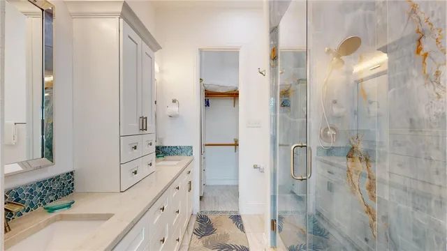 a bathroom with a double vanity sink toilet and shower