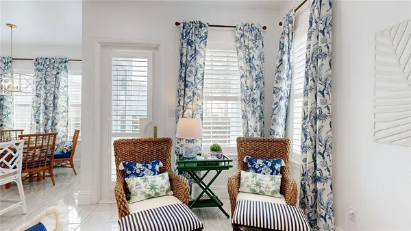 a balcony with furniture and a potted plant