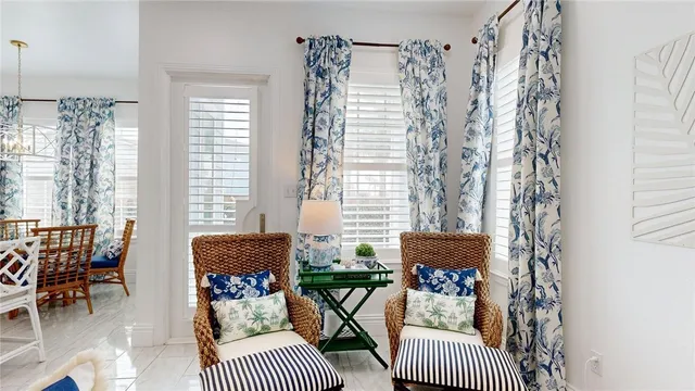 a balcony with furniture and a potted plant