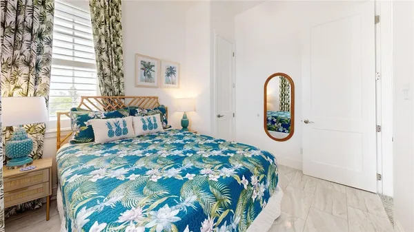 a bedroom with a bed and a painting on the wall