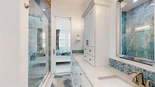 a bathroom with a tub shower and sink