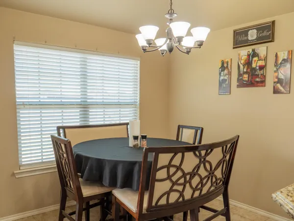 a view of a dining room with furniture and chandelier