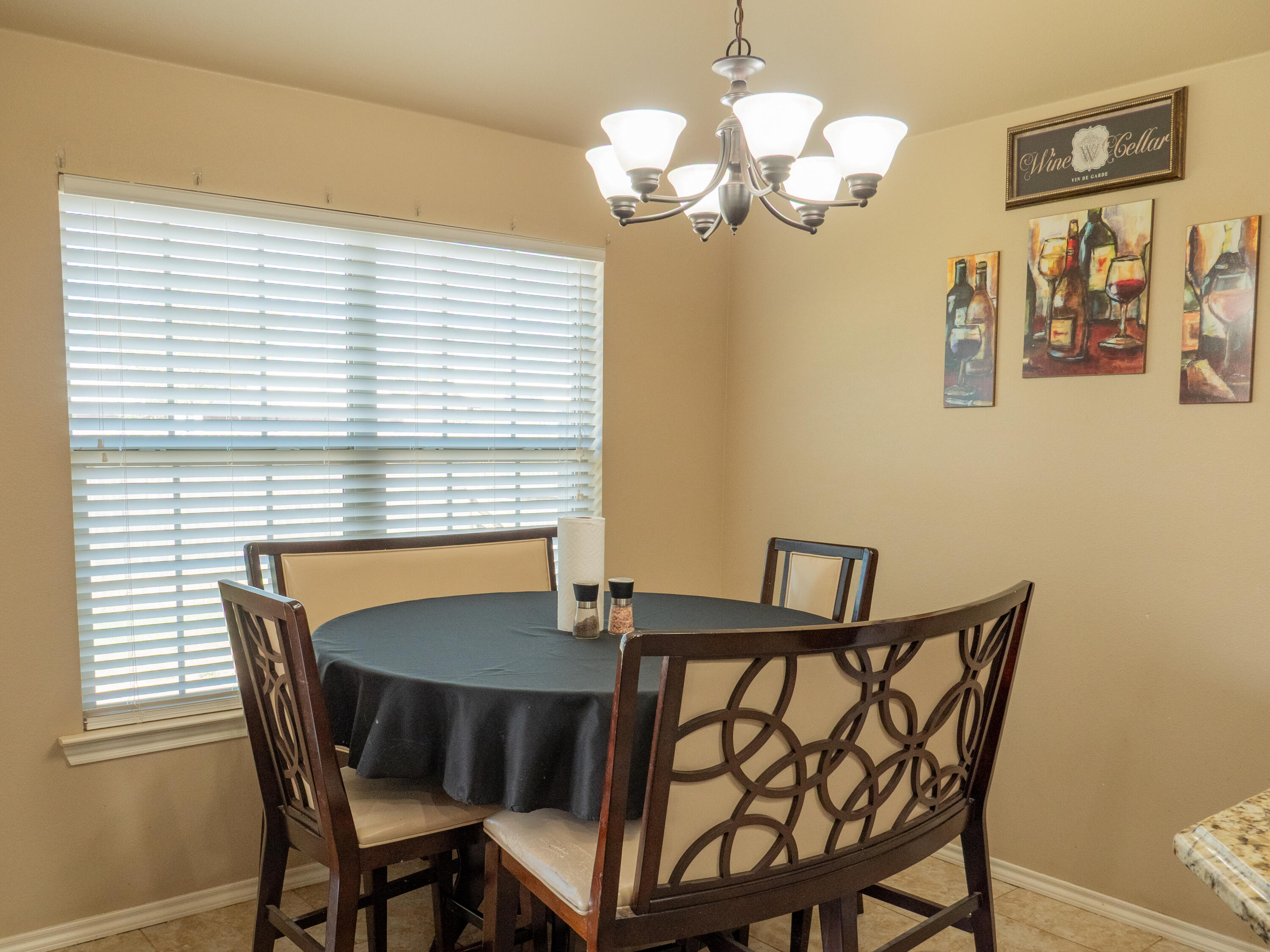 910 12th Street Wolfforth, TX 79382 - Photo 4 of 18 a view of a dining room with furniture and chandelier