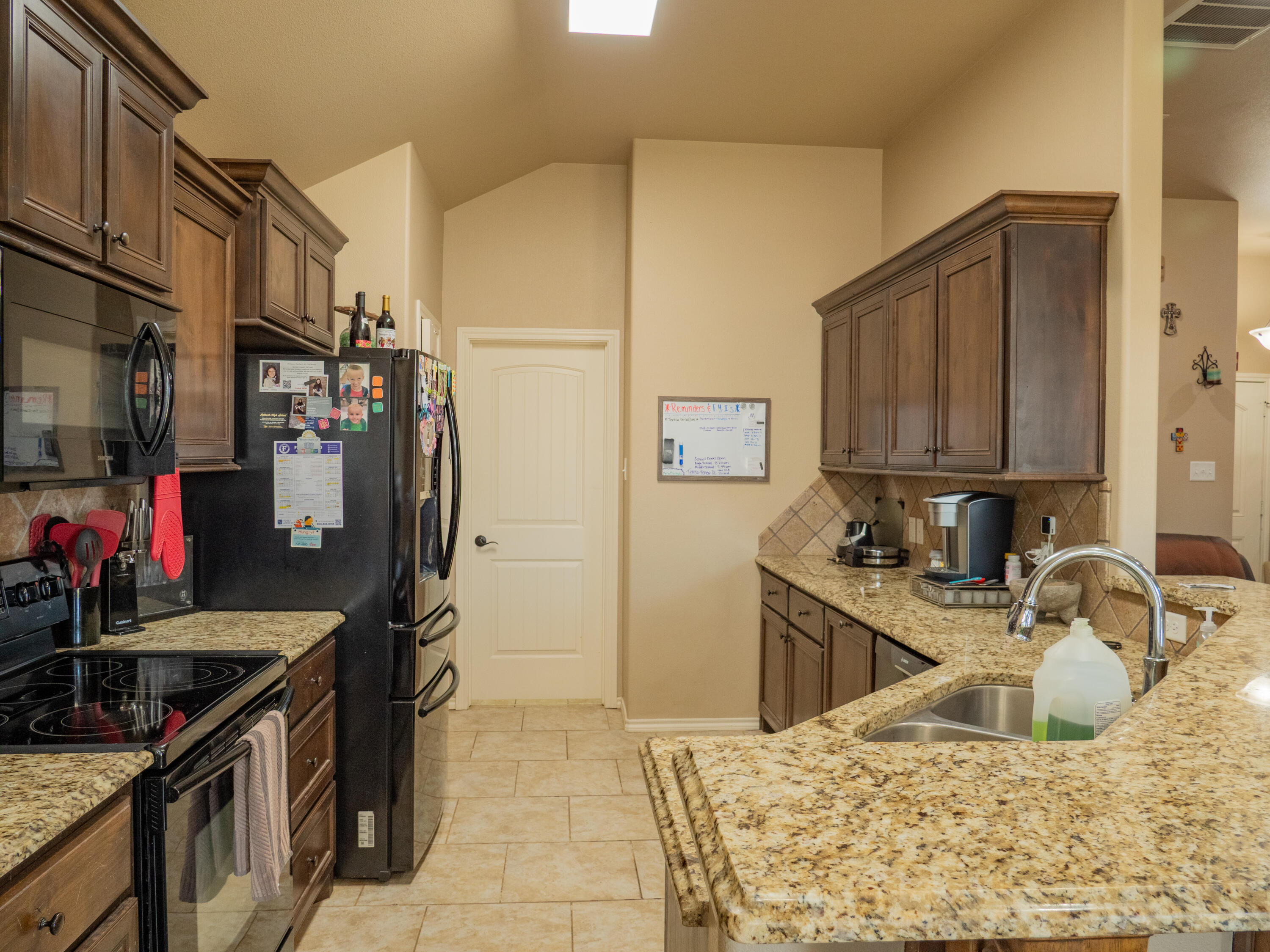 910 12th Street Wolfforth, TX 79382 - Photo 5 of 18 a kitchen with stainless steel appliances granite countertop a sink stove and refrigerator