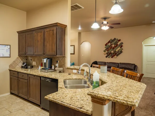 a kitchen with a sink a stove and cabinets