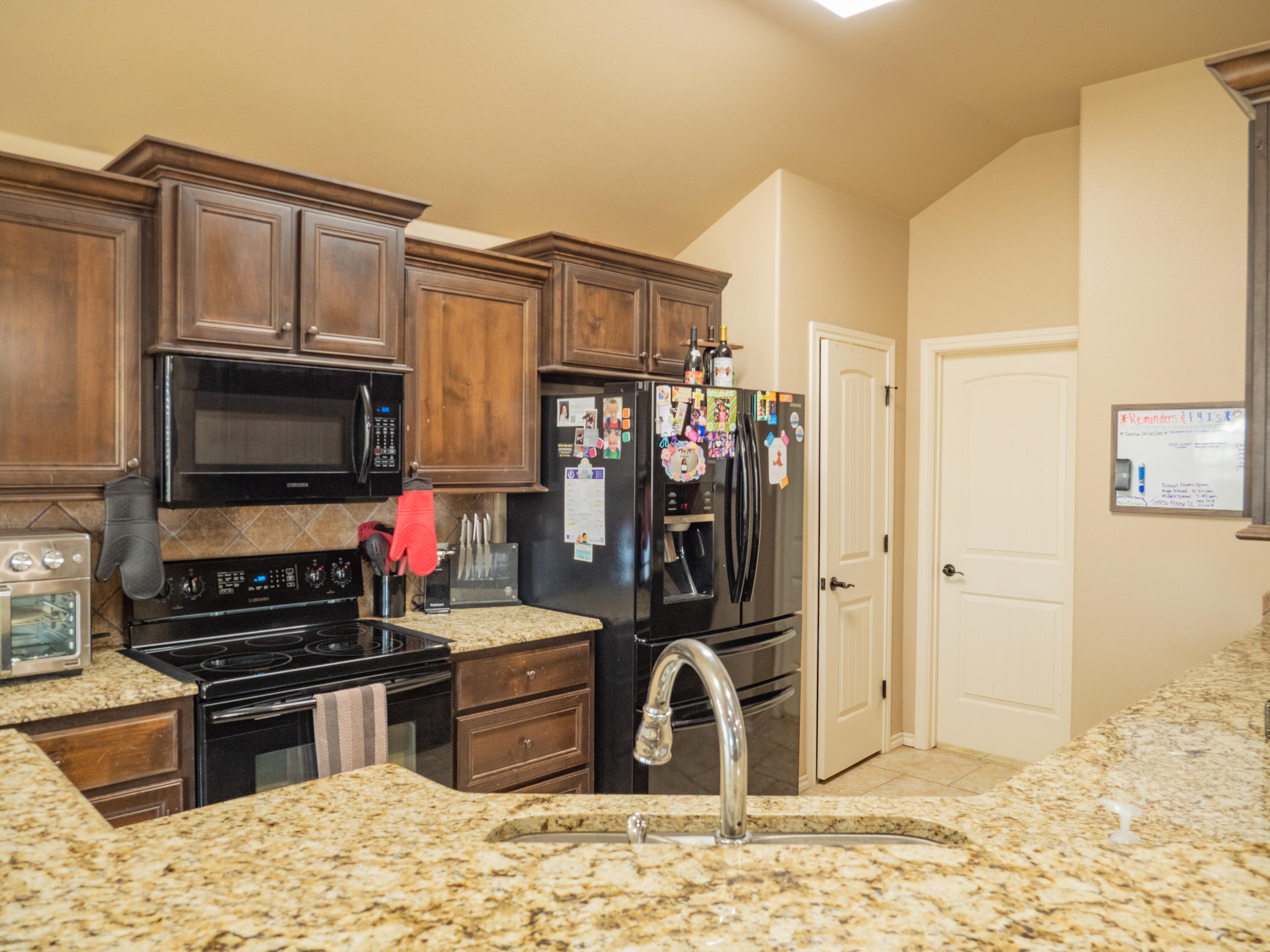 910 12th Street Wolfforth, TX 79382 - Photo 7 of 18 a kitchen with a refrigerator stove and a sink