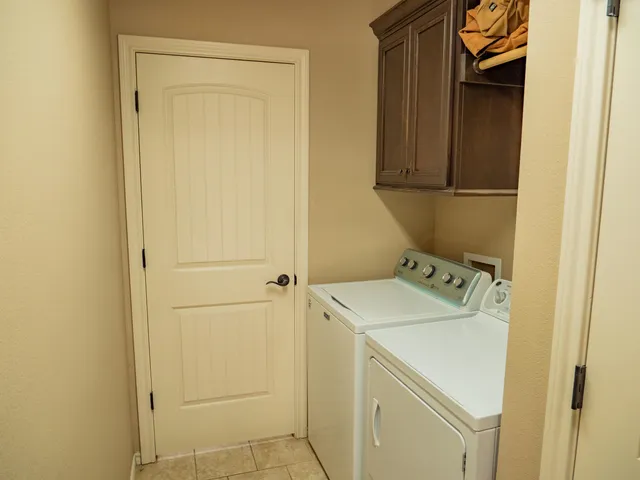 a bedroom with a bed and a chandelier fan
