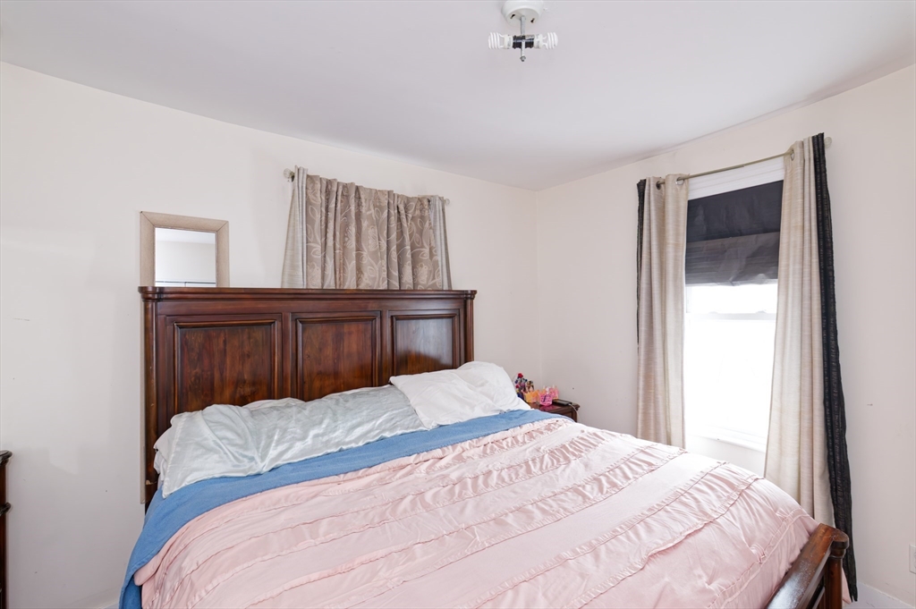 10 Rhubena Street Framingham, MA 01702 - Photo 13 of 30 a bedroom with a large bed and wooden floor