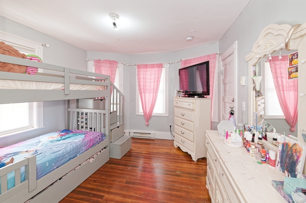 10 Rhubena Street Framingham, MA 01702 - Photo 17 of 30 a large white kitchen with wooden floor and furniture