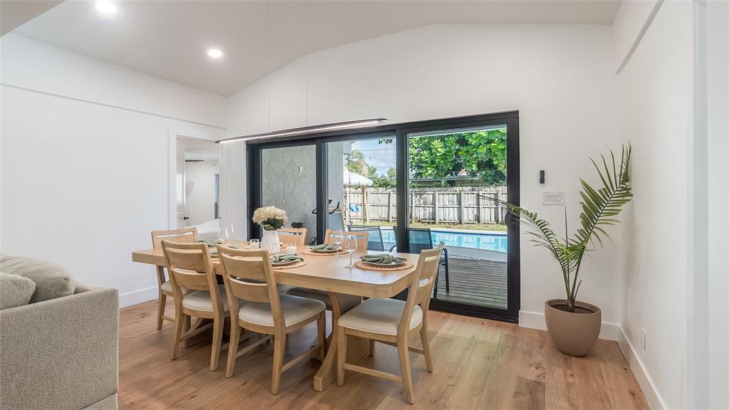 1399 West Camino Real Boca Raton, FL 33486 - Photo 10 of 45 a dining room with furniture potted plants and wooden floor