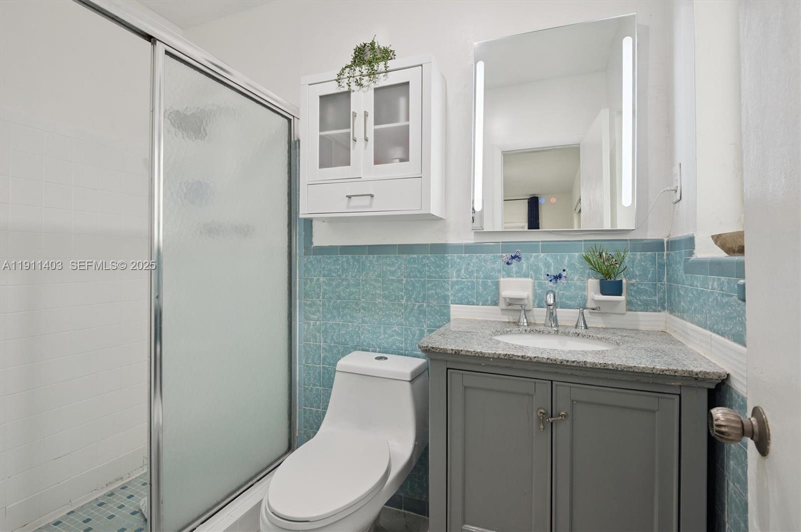 630 Northeast 175th Street Miami, FL 33162 - Photo 13 of 28 a bathroom with a sink toilet and mirror