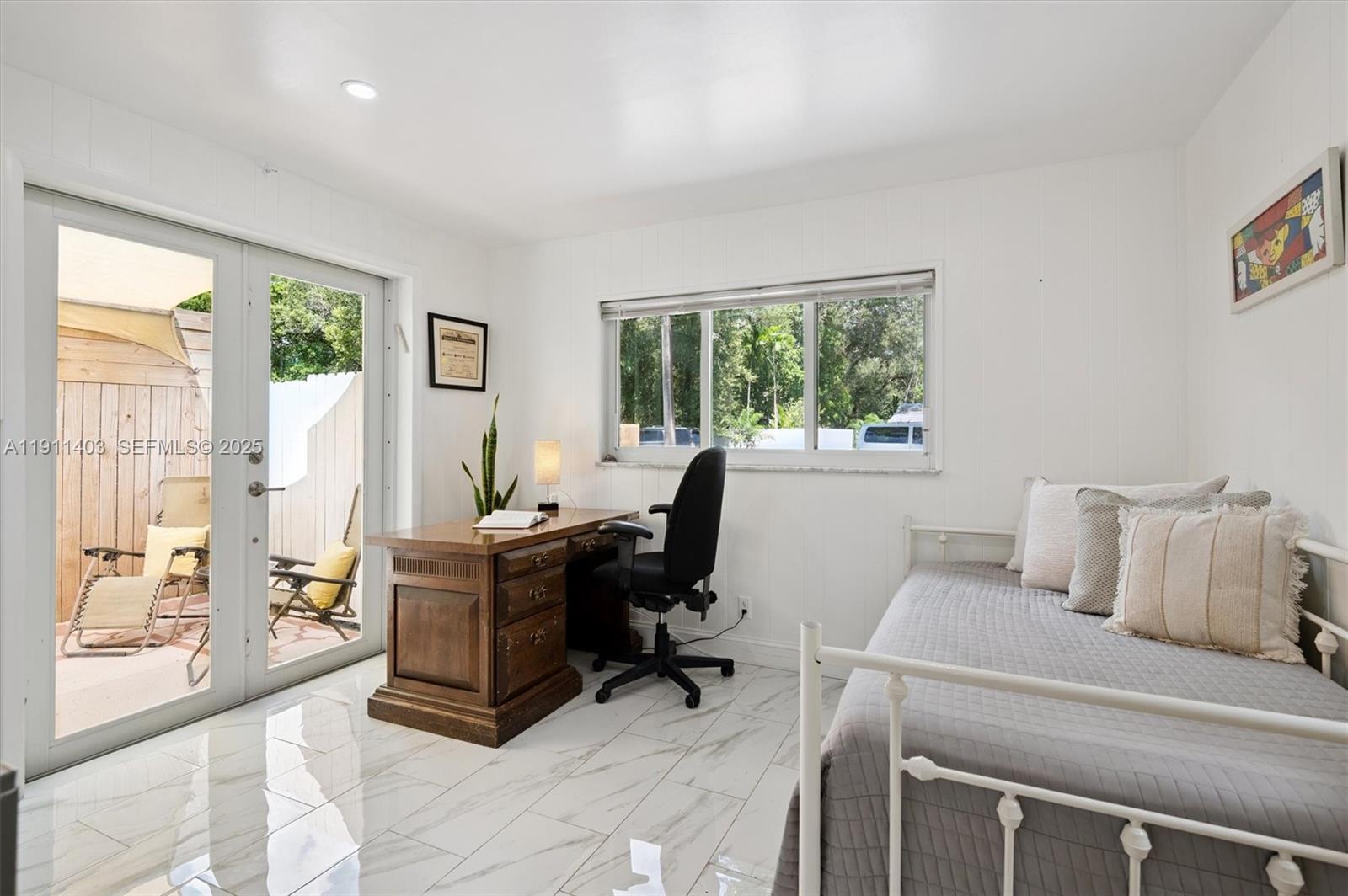 630 Northeast 175th Street Miami, FL 33162 - Photo 14 of 28 a view of a workspace with furniture and a window