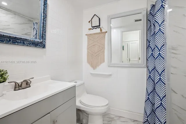 a bathroom with a sink toilet and vanity