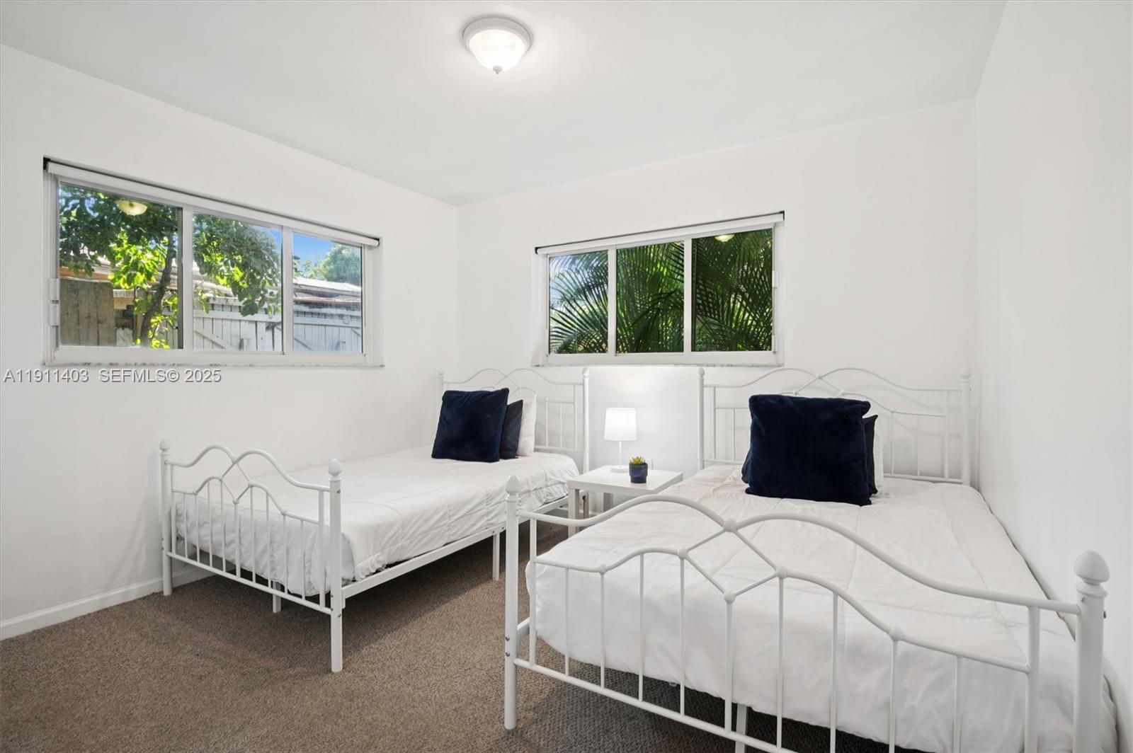 630 Northeast 175th Street Miami, FL 33162 - Photo 17 of 28 a bedroom with a bed and a window