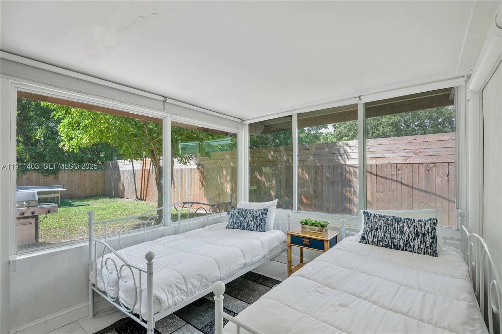 630 Northeast 175th Street Miami, FL 33162 - Photo 18 of 28 a bedroom with a bed and a large window with balcony view