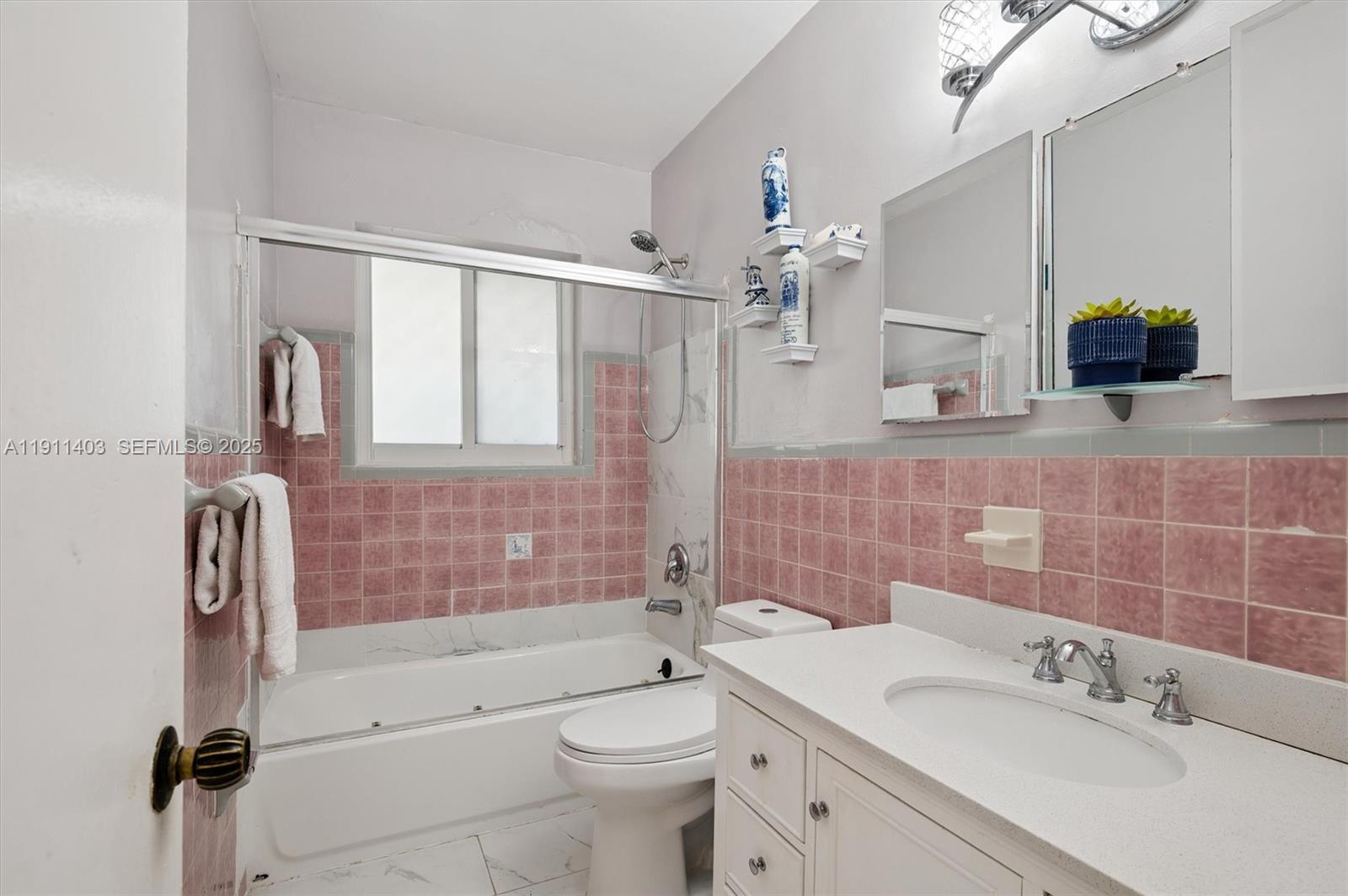 630 Northeast 175th Street Miami, FL 33162 - Photo 19 of 28 a bathroom with a double vanity sink toilet and shower