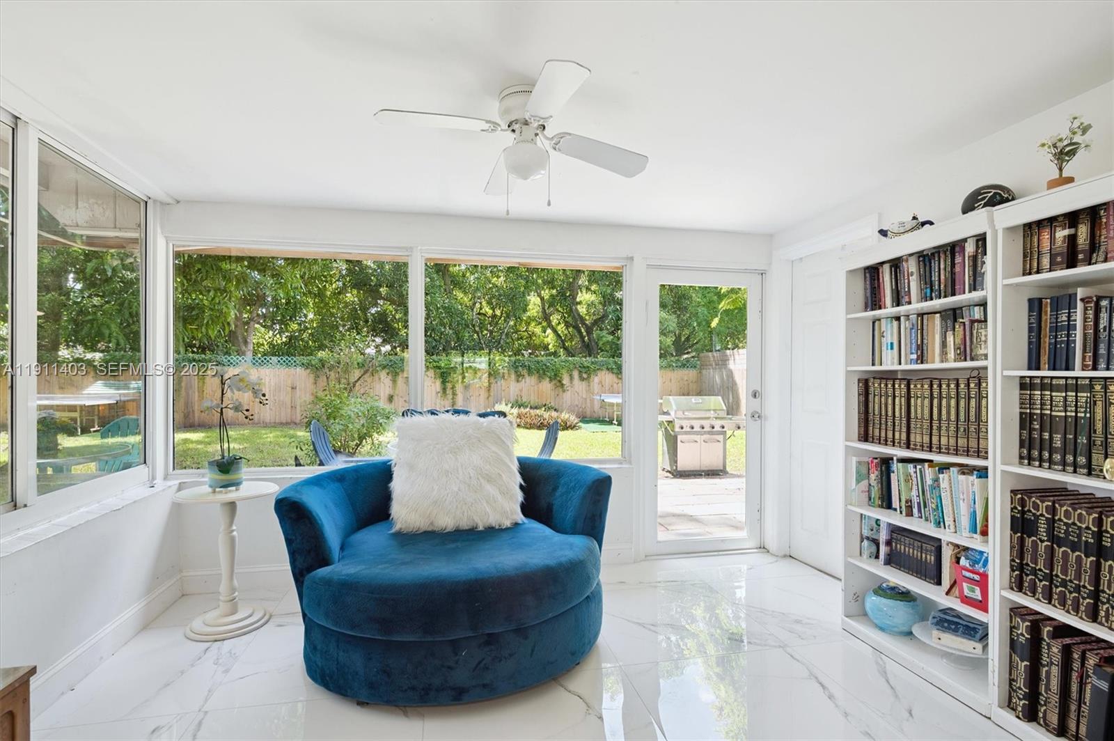 630 Northeast 175th Street Miami, FL 33162 - Photo 20 of 28 a living room with furniture and a book shelf