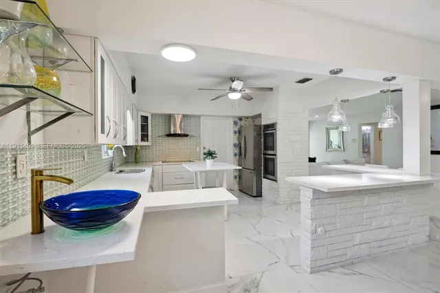 a living room with kitchen island furniture and a chandelier
