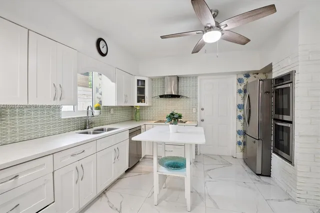a kitchen with a sink appliances and cabinets