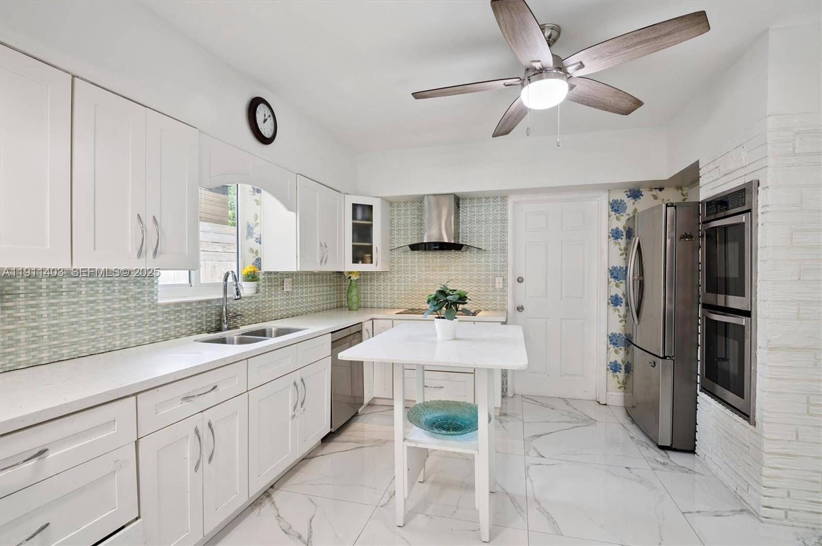 630 Northeast 175th Street Miami, FL 33162 - Photo 8 of 28 a kitchen with a sink appliances and cabinets