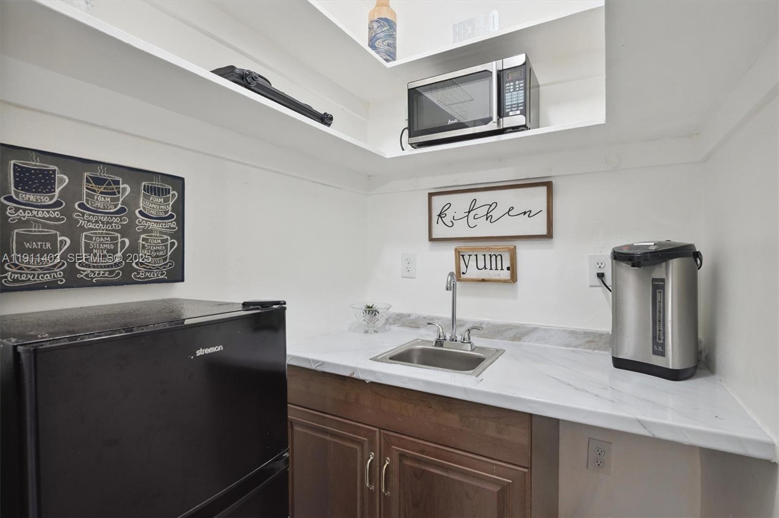 630 Northeast 175th Street Miami, FL 33162 - Photo 10 of 28 a bathroom with a sink and a mirror
