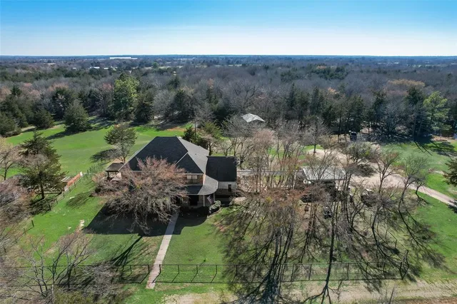 an aerial view of a house with a yard