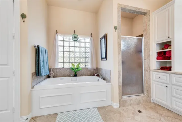 a large white kitchen with cabinets and chairs