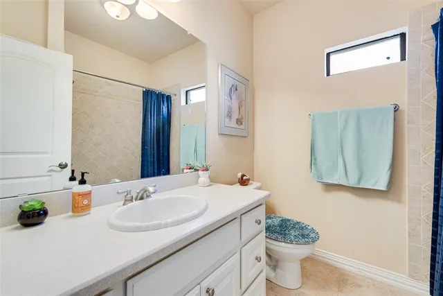 a bedroom with a bed chandelier and a window