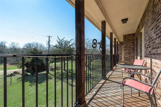 a view of balcony with wooden floor and fence