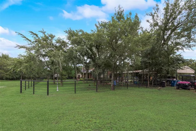 a view of a patio with table and chairs floor to ceiling with wooden floor and fence